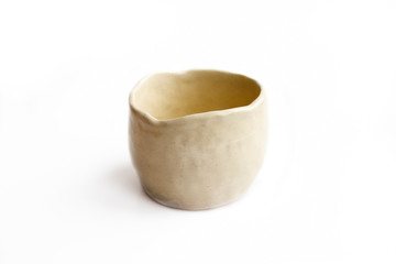 Clay cup, made by hand from white clay. Double burning. Transparent glaze applied by hand. Handmade, single copy. White background, isolated