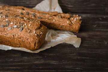 close up view of chrono breads on dark wooden background with copy space