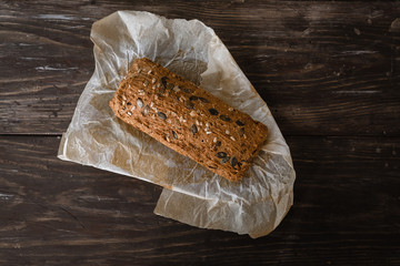 isolated top view of chrono bread on dark brown wooden background