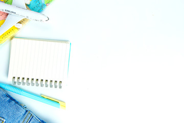 costumes concept for summer vacation trip. Passports, luggage, map, smartphone,sun glasses,camera, note pad, jean on white