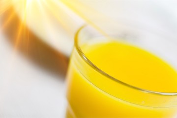 Close-up of fresh orange drinks on table background