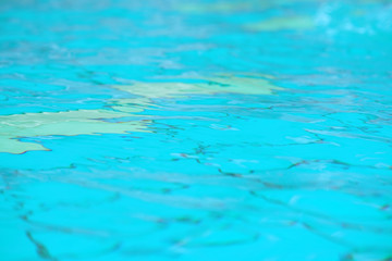 Pure blue water in the pool. Water background. Swimming pool bottom caustics ripple and flow with...