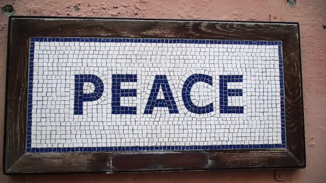 The word peace tiled on a raked wall inscription in Nicosia cyprus 2001