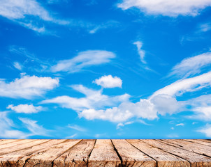 Wooden table top and blue sky background