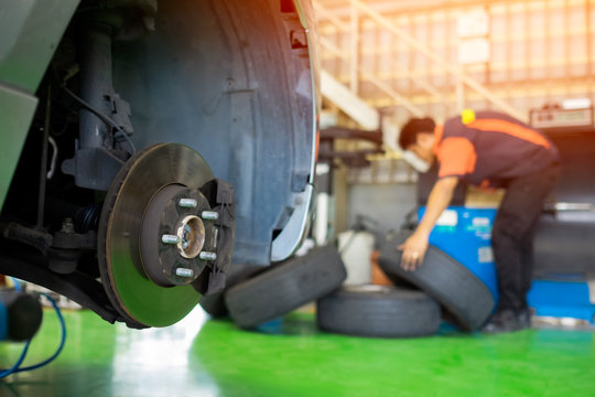 Car without wheels during tire change.