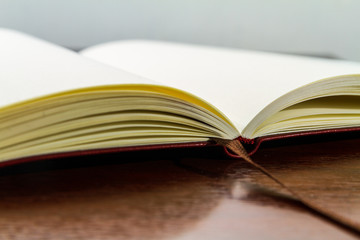 Blank textbook with a dark wood table isolated 