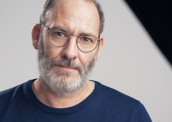 Portrait of a bearded mature adult casual Businessman looking into 