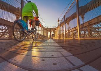 a magnificent view of Brooklyn Bridge with cyclist