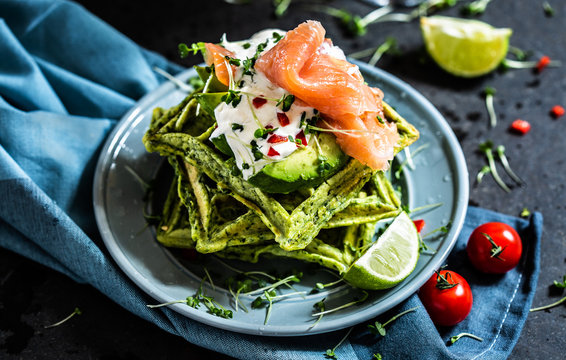 Spinach waffles with avocado and smoked salmon