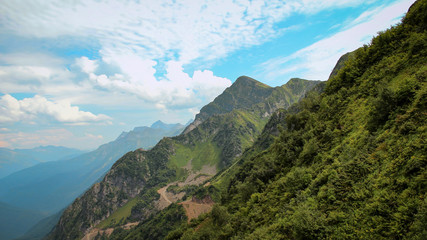 View of the green slopes of the mountains in the summer on a hot sunny day