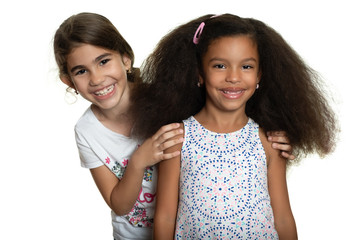 Cute hispanic and african-american small girls hugging