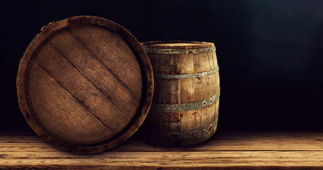 Worn old wooden barrels on desk and free space for your decoration 