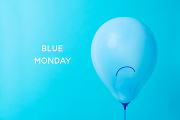 blue balloon with a sad face and text blue monday