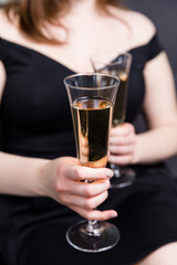 Valentines day romance, beautiful woman holding champagne glasses in hands,close up.