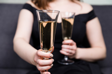 Valentines day romance, beautiful woman holding champagne glasses in hands,close up.