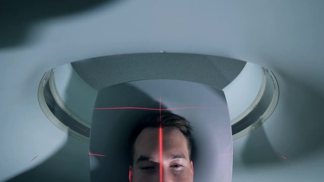 Patient getting into tomographic machine, top view.