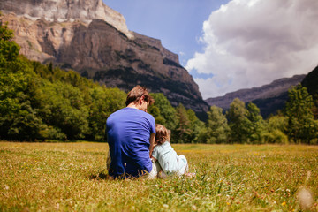Father and daughter sitting in nature