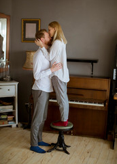 Loving young couple kissing in the room
