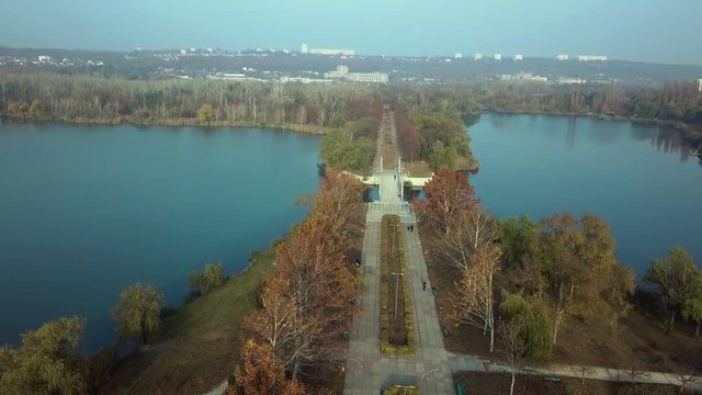 Aerial footage over Echo Park Lake, Kishinev, Moldova republic of. View of lake and smille bridge.