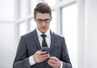 young businessman reading SMS on his smartphone