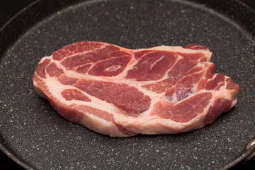 Pork steak in non-stick frying pan