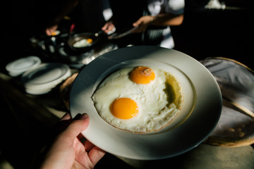 Holding a fried egg