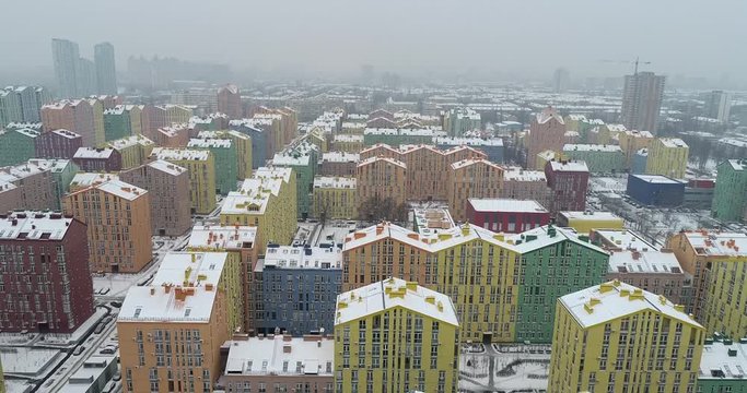 Aerial view. City district of happiness. Drone flying above colorful houses. Camera moves back. Kiev city, Ukraine. 4K, 50 fps.
