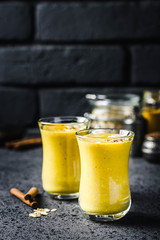 Oatmeal turmeric smoothie on dark background. Selective focus, space for text.
