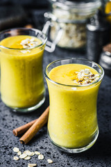Oatmeal turmeric smoothie on dark background. Selective focus, space for text.
