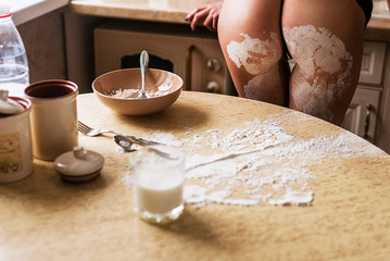 Sexy girl cooks in the kitchen, nude, flour