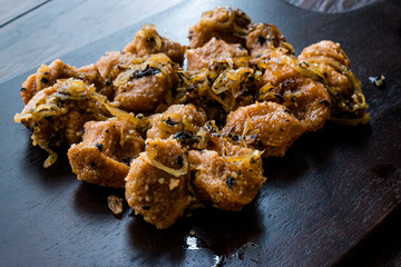 Turkish Sikma Kofte Bulgur Meatballs with Caramelized Onions / Fellah Bulghur Kofta on Wooden Board.