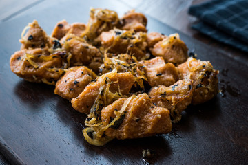 Turkish Sikma Kofte Bulgur Meatballs with Caramelized Onions / Fellah Bulghur Kofta on Wooden Board.