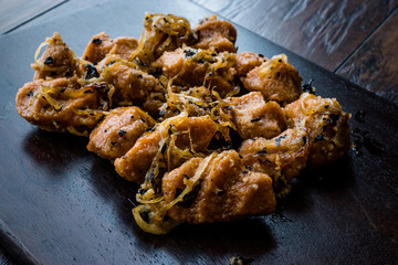 Turkish Sikma Kofte Bulgur Meatballs with Caramelized Onions / Fellah Bulghur Kofta on Wooden Board.