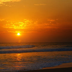 Beach of the ocean and golden sun rise.