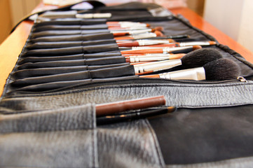 Tablet with tassels for make-up. Many different brushes. A variety of shapes and sizes. A set of brushes on the table. Macro photography.