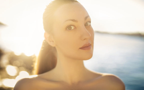 Beautiful naked girl standing in front of the sea