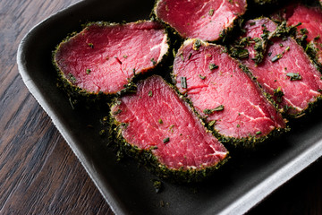 Package of Raw Tenderloin Meat with Herbs and Spices in Plastic Box / Container.