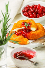 Baked or fried Camembert or brie cheese with cranberry and rosemary sauce. Gourmet Breakfast. Selective focus