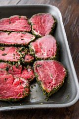 Package of Raw Tenderloin Meat with Herbs and Spices in Plastic Box / Container.