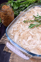 Holodets chicken meat jelly in a glass dish and a jar of mustard