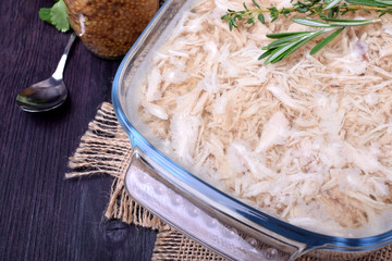 Holodets chicken meat jelly in a glass dish and a jar of mustard