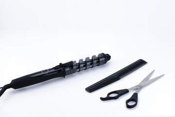 Grey hair iron with accessory on the white background with copy space.