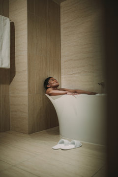 Mature Woman Taking Bath In Bathtub