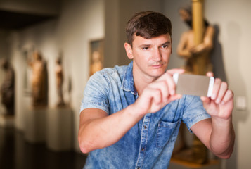 Man taking pictures in historical museum
