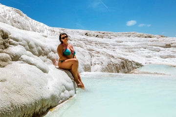 Girl posing near the thermal springs and travertines of Pamukkale