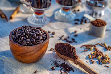 Coffee still life golden morning light on coffee mugs, whole coffee beans, ground coffee