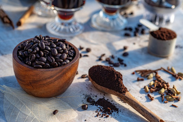 Coffee beans, ground coffee, coffee mugs early morning still life