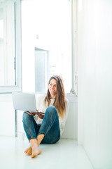 Attractive woman with laptop at home