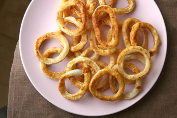 Fried squid rings in plate. Snack calamari rings.