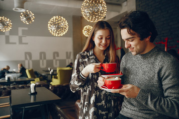 Cute couple spend time in a cafe